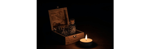 travel witch kit with wooden box, herbs, and candle lit for ritual use