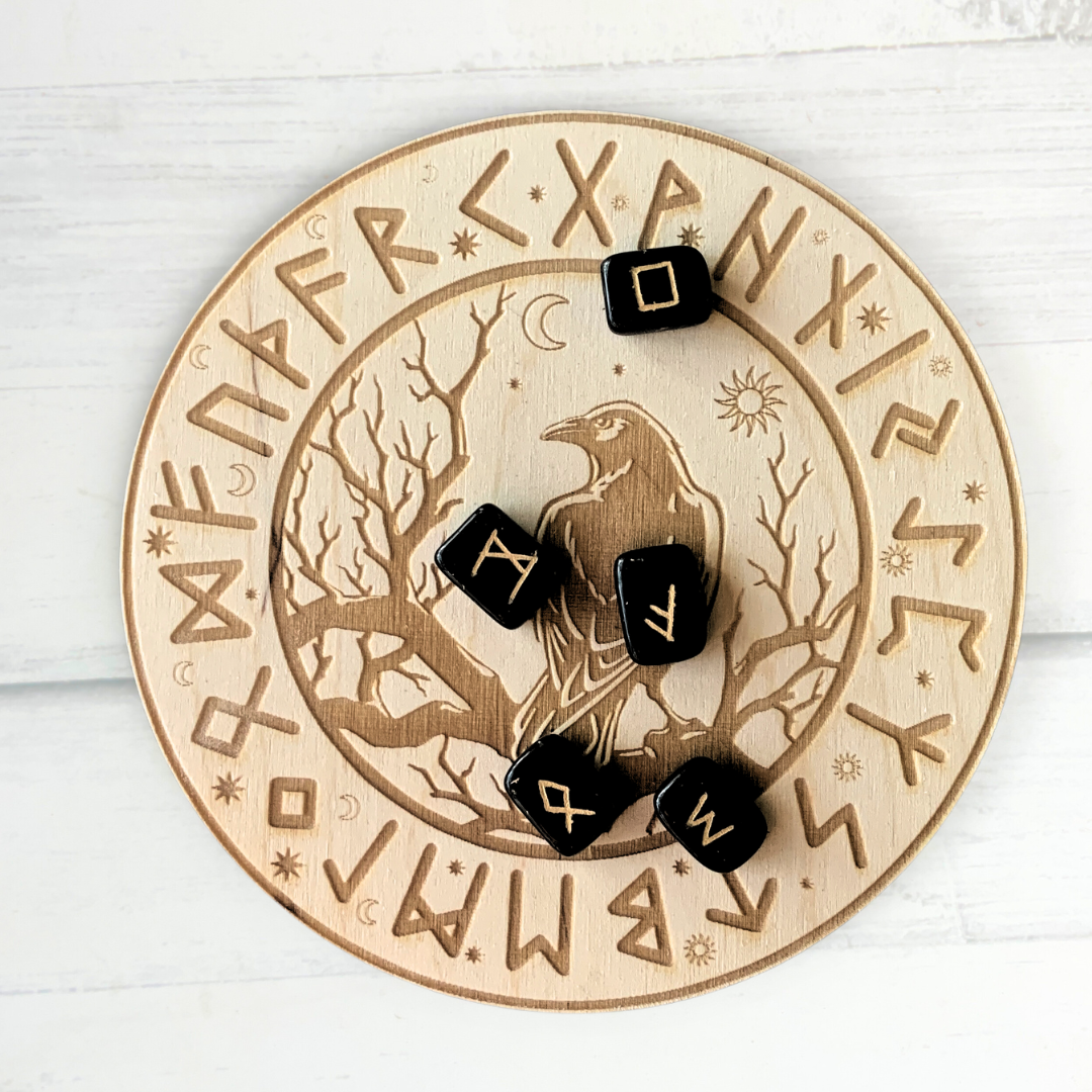 Wooden casting board with runes and image of raven