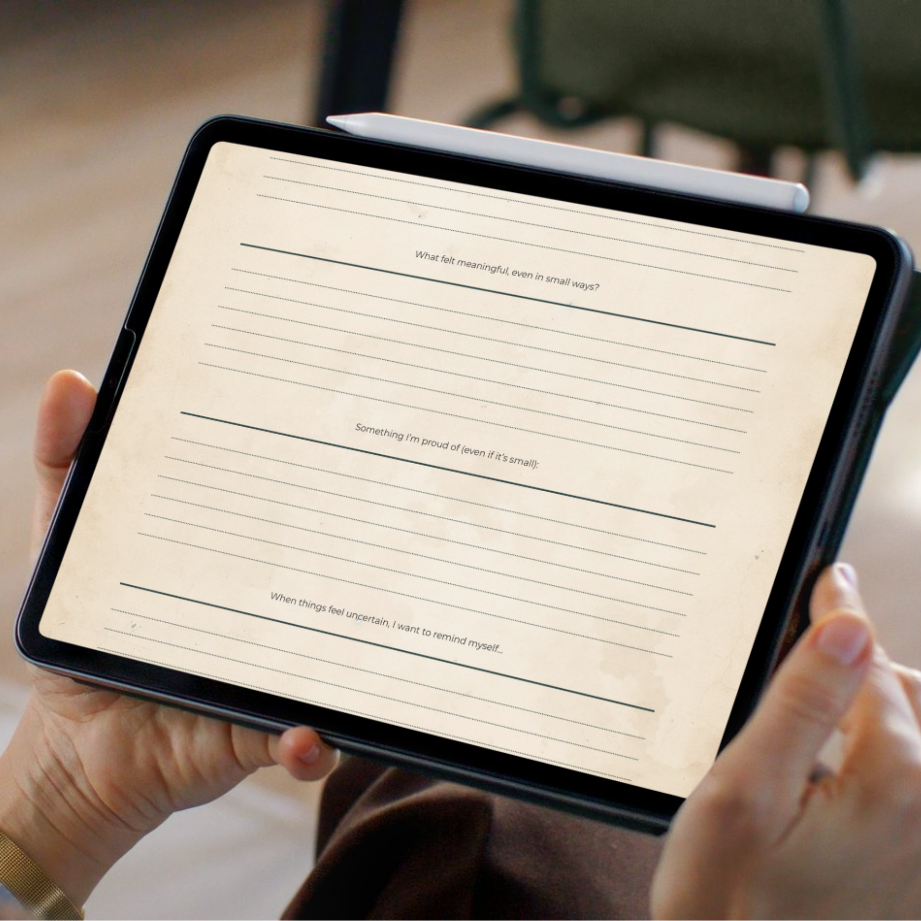 Person holding a tablet with a writing app open on the screen.